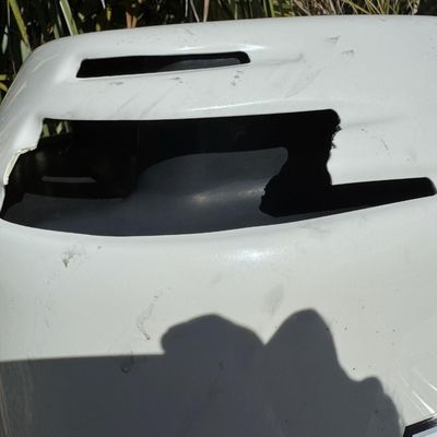 Sale Photo Thumbnail #30: Includes everything pictured, including Four Winns trailer. Johnson 150hp Ocean Pro outboard motor, production date 8/2000. Eighteen foot hull. The motor turns over, but is not firing. The engine cowling has a crack (pictured). This boat is pretty clean. 