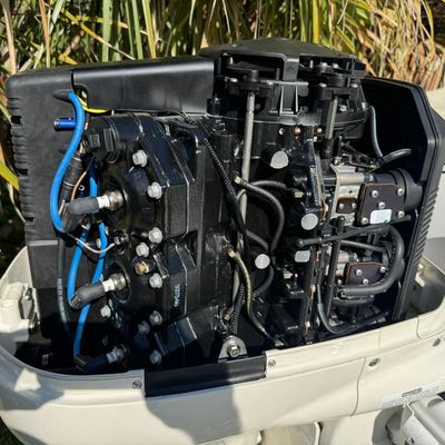 Sale Photo Thumbnail #31: Includes everything pictured, including Four Winns trailer. Johnson 150hp Ocean Pro outboard motor, production date 8/2000. Eighteen foot hull. The motor turns over, but is not firing. The engine cowling has a crack (pictured). This boat is pretty clean. 