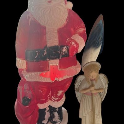Sale Photo Thumbnail #179: Includes an angel, and Santa Claus. Total of two piece. There is age related wear, including paint loss on the angel, and plastic damage on Santa. Measurement of tallest: 62”H.