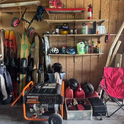 Sale Photo Thumbnail #210: Includes vintage water skis, golf clubs, a Generac GP5500 generator, gas cans, and more. The generator is running at the time of catalog.