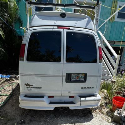 Sale Photo Thumbnail #250: 4.3 liter V-6 engine. Believed to be an Express 1500. Southern Comfort Conversion, Model number CG11405. VIN: 1GBFG15R021237737. Needs a new battery, but is running at the time of catalog. The back seats have been removed, but are included. Various other 