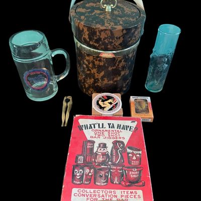 Sale Photo Thumbnail #317: Includes a mid-century NOS boxed set of novelty “What’ll Ya Have?” Bar jiggers and shot glasses made in Japan; a set of six “naughty” coasters; a Mabel’s Whore House glass mug; a vintage ice bucket; and more. Total of seven pieces.