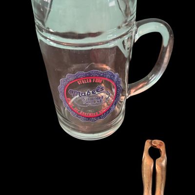 Sale Photo Thumbnail #319: Includes a mid-century NOS boxed set of novelty “What’ll Ya Have?” Bar jiggers and shot glasses made in Japan; a set of six “naughty” coasters; a Mabel’s Whore House glass mug; a vintage ice bucket; and more. Total of seven pieces.