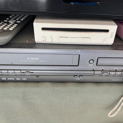 Sale Photo Thumbnail #324: Includes a 54” Roku television, a Magnavox VHS/DVD player, a Marantz Legacy Series cassette DA452, a Sony receiver, a JBL Bluetooth speaker, DVDs, a Wii console with two remotes, and more. Not tested.