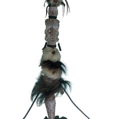 Sale Photo Thumbnail #330: This is a vintage primitive carved wood figural tiki totem kinetic balancing art sculpture. It features natural fibers and feathers. There is age related wear. Measurement: 51”H.