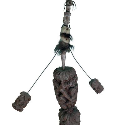 Sale Photo Thumbnail #329: This is a vintage primitive carved wood figural tiki totem kinetic balancing art sculpture. It features natural fibers and feathers. There is age related wear. Measurement: 51”H.