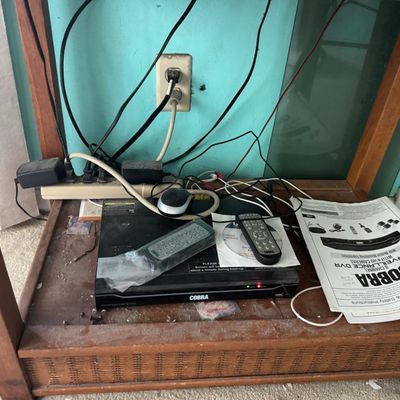 Sale Photo Thumbnail #339: Includes a 40” Roku television, a Magnavox VHS/DVD player, speakers, and more. Total of five pieces. Not tested.