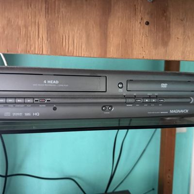 Sale Photo Thumbnail #337: Includes a 40” Roku television, a Magnavox VHS/DVD player, speakers, and more. Total of five pieces. Not tested.
