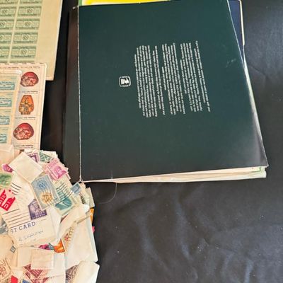 Sale Photo Thumbnail #396: Includes numerous U.S. and foreign stamps, along with sleeves and collector books.