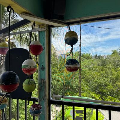 Sale Photo Thumbnail #404: Includes vintage crab trap buoys, whirligigs, painted coconuts, and more. Winning bidder must take these down.