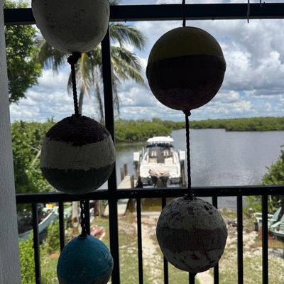 Sale Photo Thumbnail #402: Includes vintage crab trap buoys, whirligigs, painted coconuts, and more. Winning bidder must take these down.
