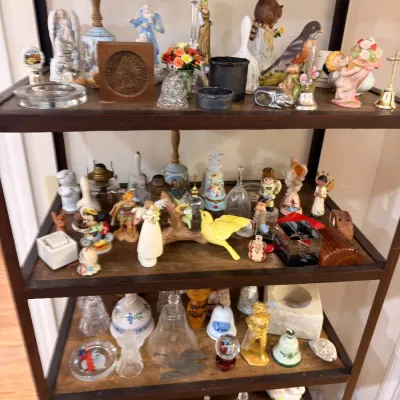 Sale Photo Thumbnail #520: Etagere of collectible bells and porcelain figurines