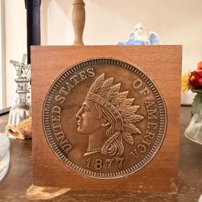 Sale Photo Thumbnail #521: Carved wood 1877 Indian Head penny plaque