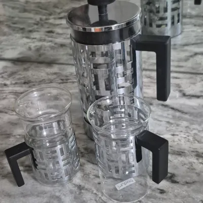 Sale Photo Thumbnail #40: Bodum Eileen French Press coffee maker set with two matching glass mugs featuring distinctive geometric metal frames and black handles
all PCs. marked Bodum......very low usage if at all
All =perfect condition...no damage or cracks
coffee recipe included.