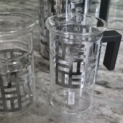 Sale Photo Thumbnail #36: Bodum Eileen French Press coffee maker set with two matching glass mugs featuring distinctive geometric metal frames and black handles
all PCs. marked Bodum......very low usage if at all
All =perfect condition...no damage or cracks
coffee recipe included.