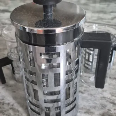 Sale Photo Thumbnail #38: Bodum Eileen French Press coffee maker set with two matching glass mugs featuring distinctive geometric metal frames and black handles
all PCs. marked Bodum......very low usage if at all
All =perfect condition...no damage or cracks
coffee recipe included.