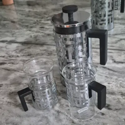 Sale Photo Thumbnail #35: Bodum Eileen French Press coffee maker set with two matching glass mugs featuring distinctive geometric metal frames and black handles
all PCs. marked Bodum......very low usage if at all
All =perfect condition...no damage or cracks
coffee recipe included.