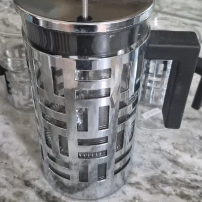 Sale Photo Thumbnail #39: Bodum Eileen French Press coffee maker set with two matching glass mugs featuring distinctive geometric metal frames and black handles
all PCs. marked Bodum......very low usage if at all
All =perfect condition...no damage or cracks
coffee recipe included.