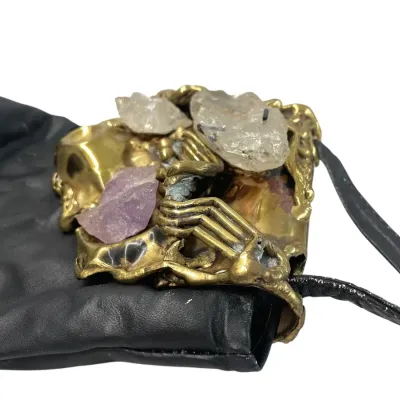 Sale Photo Thumbnail #66: Freeform brass sculpture featuring raw quartz and amethyst, forming the top of the purse.

Original label says: Carvalhu's / Made in Brazil.

This artistic closure is on a leather purse by Leo Martel, made in Mexico, with original label.
Scuffs and few mi