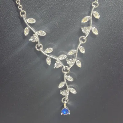 Sale Photo Thumbnail #76: > thick braided chain link necklace w/lobster clasp.....20"
> delicate pearl and stone spaced choker 
> silver tone leaf cluster w/blue rhinestone dangle
all in excellent condition
