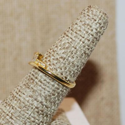 Size 6 ¼ Single Round Clear Main Stone with Side Accents on an Overlap Style Gold Tone Band (2.0g)