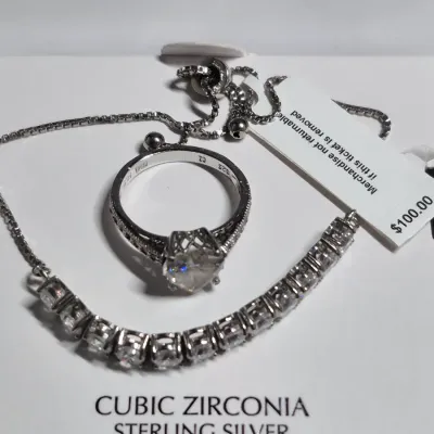 Sale Photo Thumbnail #87: Cubic CZ Necklace on sterling chain & CZ Ring HEP
> original box for the Cubic CZ necklace marked $100
> CZ ring is HEP electroplated.
both are new as found