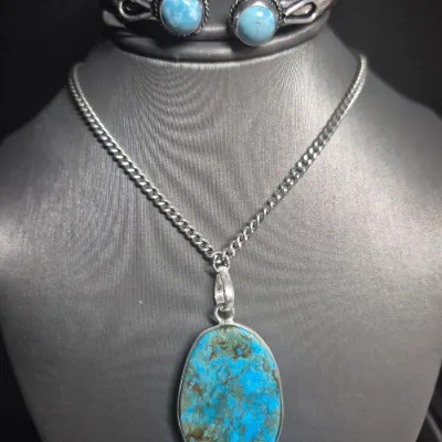 Sale Photo Thumbnail #127: Navajo Sterling Silver Blue Spiderweb Turquoise Necklace Pendant & Cuff Bracelet
> pendant marked 925, on sterling continuous chain 18'
> stone set in sterling bezel
> cuff bracelet has 2 turquoise stones at opening.
great set