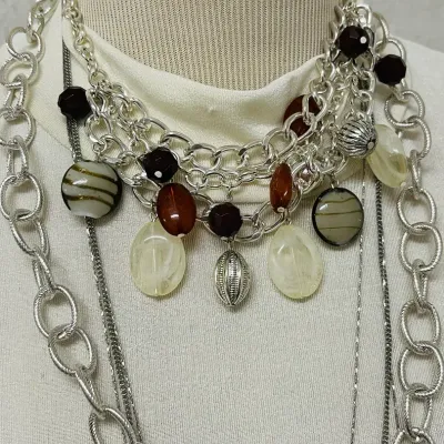 Sale Photo Thumbnail #140: Statement fashion jewelry assortment with a bold mix of layered necklaces, earrings and coordinating sets featuring turquoise-tone accents, smoky and metallic beads, faceted crystals, rhinestones, black cabochons, cat-eye style stones, chunky chains, pend