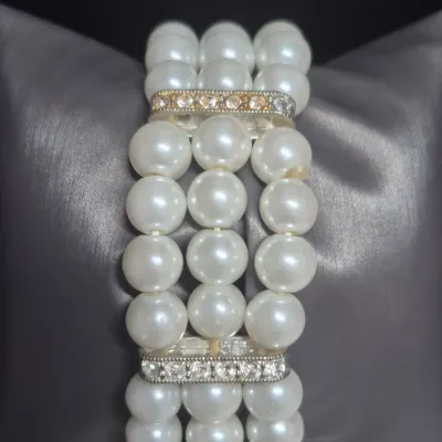 Sale Photo Thumbnail #168: Cici & Faye quartz watch  on multi strand Pearl / Rhinestone Bracelet
> watch has chrome bezel with rhinestone flanking bars
> bracelet is faux pears 3 strands stretch bracelet w/ gold inset rhinestones
> watch battery installed [cost $20]