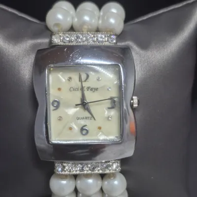 Sale Photo Thumbnail #169: Cici & Faye quartz watch  on multi strand Pearl / Rhinestone Bracelet
> watch has chrome bezel with rhinestone flanking bars
> bracelet is faux pears 3 strands stretch bracelet w/ gold inset rhinestones
> watch battery installed [cost $20]