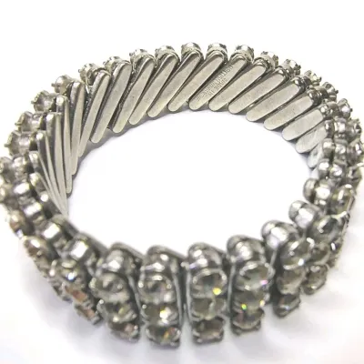 Sale Photo Thumbnail #180: Three Row Rhinestone Stretch Bracelet Vintage Silver Tone British Hong Kong ~1950-60s
Measurements from 6" up to 8.5"
Marked British Hong Kong
Good vintage condition