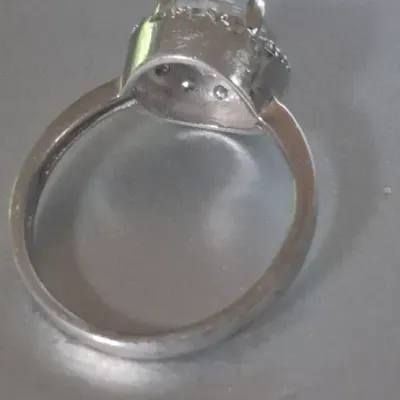 Sale Photo Thumbnail #227: Sterling Engagement Ring w/ CZ white zircon [ size 8.25 ]
Marked CFJ , located in Saginaw , Tx 1983.
Ring has a center CZ White Zircon in a halo setting
excel. condition, no scuffs to naked eye