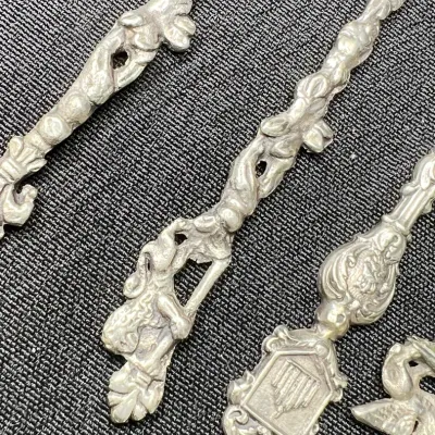 Sale Photo Thumbnail #232: Mid to late 20th century vintage / antique/ silver / silverplated / pewter souvenir spoons. 
marked ITALY Montagnani on spoon bowls
pewter, all great condition, no bends or breaks.
polished to tone