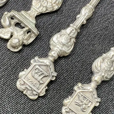 Sale Photo Thumbnail #231: Mid to late 20th century vintage / antique/ silver / silverplated / pewter souvenir spoons. 
marked ITALY Montagnani on spoon bowls
pewter, all great condition, no bends or breaks.
polished to tone