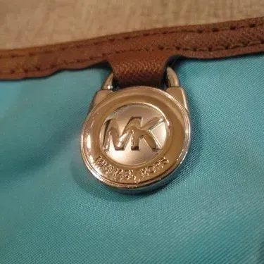 Sale Photo Thumbnail #329: MICHAEL KORS Woman's Kempton Crossbody bag in a  lovely shade of blue- features brown leather trim and  adjustable leather shoulder strap - with gold-tone "MK" Logo charm on the front. water resistant Nylon with multiple exterior and interior pockets. Han