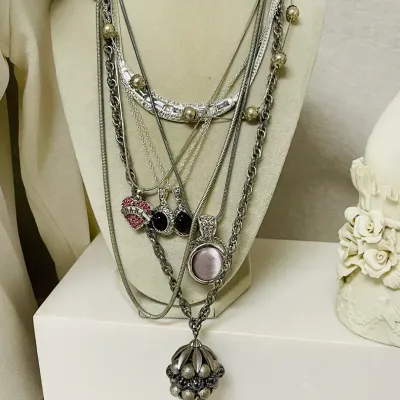 Sale Photo Thumbnail #362: Statement fashion jewelry assortment with a bold mix of layered necklaces, earrings and coordinating sets featuring turquoise-tone accents, smoky and metallic beads, faceted crystals, rhinestones, black cabochons, cat-eye style stones, chunky chains, pend