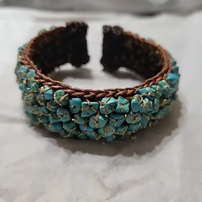 Sale Photo Thumbnail #406: Woven Bracelet Turquoise Colored Stones expandable Cuff, Brown colored with turquoise colored stones, Untested.
All stones are individually wrapped and tied.
Boho or native American style.......excellent condition