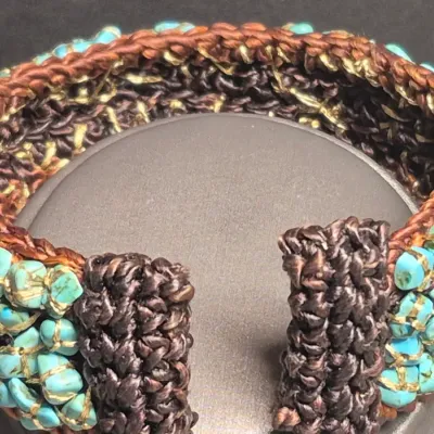 Sale Photo Thumbnail #404: Woven Bracelet Turquoise Colored Stones expandable Cuff, Brown colored with turquoise colored stones, Untested.
All stones are individually wrapped and tied.
Boho or native American style.......excellent condition