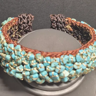 Sale Photo Thumbnail #402: Woven Bracelet Turquoise Colored Stones expandable Cuff, Brown colored with turquoise colored stones, Untested.
All stones are individually wrapped and tied.
Boho or native American style.......excellent condition