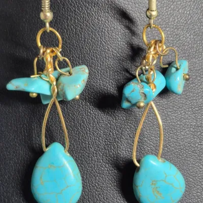 Sale Photo Thumbnail #421: turquoise or dyed turquoise-howlite beaded necklace and matching drop earring set featuring large, graduated round and carved melon beads
Earrings are turquoise chips strung on gold wire, pierced