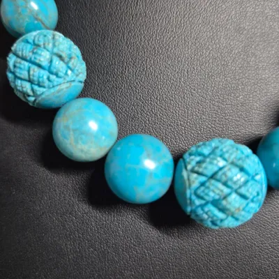 Sale Photo Thumbnail #418: turquoise or dyed turquoise-howlite beaded necklace and matching drop earring set featuring large, graduated round and carved melon beads
Earrings are turquoise chips strung on gold wire, pierced