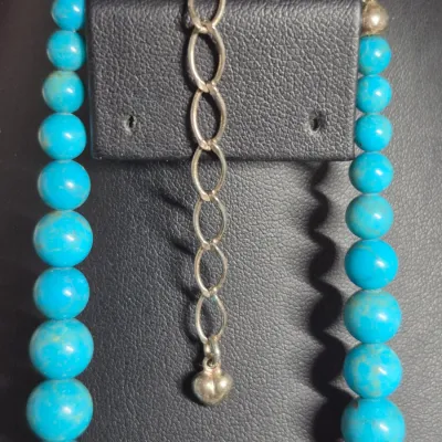 Sale Photo Thumbnail #420: turquoise or dyed turquoise-howlite beaded necklace and matching drop earring set featuring large, graduated round and carved melon beads
Earrings are turquoise chips strung on gold wire, pierced