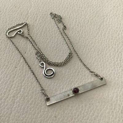 Minimalist silver bar necklace, featuring a small Denzel set red garnet or ruby gemstone on a delicate chain