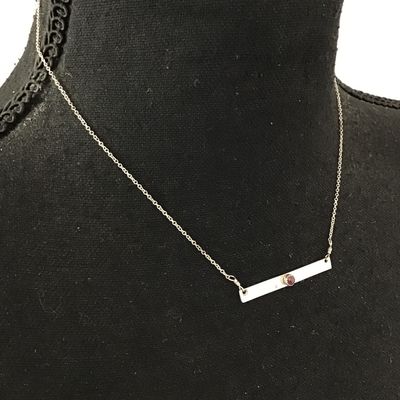 Minimalist silver bar necklace, featuring a small Denzel set red garnet or ruby gemstone on a delicate chain