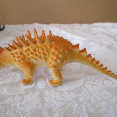 Sale Photo Thumbnail #576: 2 Stegosaurus 1-12" long, 1- 9.5" long; 1 ankylosaurus 6" long; 1 duck-billed Trachodon 5.5" long; See pictures
