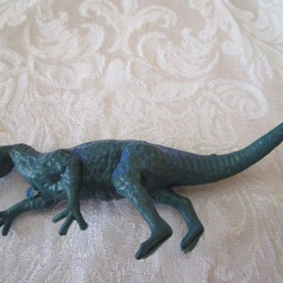 Sale Photo Thumbnail #572: 2 Stegosaurus 1-12" long, 1- 9.5" long; 1 ankylosaurus 6" long; 1 duck-billed Trachodon 5.5" long; See pictures