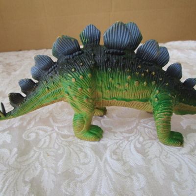 Sale Photo Thumbnail #586: 2 Stegosaurus 1-12" long, 1- 9.5" long; 1 ankylosaurus 6" long; 1 duck-billed Trachodon 5.5" long; See pictures