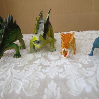 Sale Photo Thumbnail #570: 2 Stegosaurus 1-12" long, 1- 9.5" long; 1 ankylosaurus 6" long; 1 duck-billed Trachodon 5.5" long; See pictures