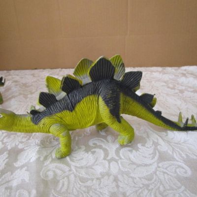 Sale Photo Thumbnail #580: 2 Stegosaurus 1-12" long, 1- 9.5" long; 1 ankylosaurus 6" long; 1 duck-billed Trachodon 5.5" long; See pictures