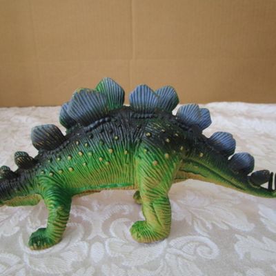 Sale Photo Thumbnail #585: 2 Stegosaurus 1-12" long, 1- 9.5" long; 1 ankylosaurus 6" long; 1 duck-billed Trachodon 5.5" long; See pictures